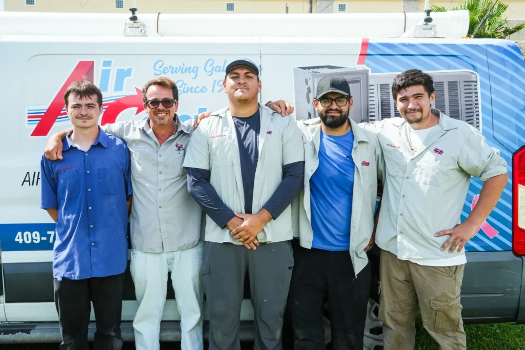 team photo of five guys standing in front of a work van